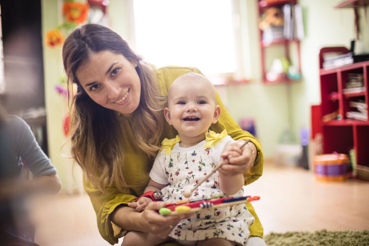 Childcareworkerholdingbaby