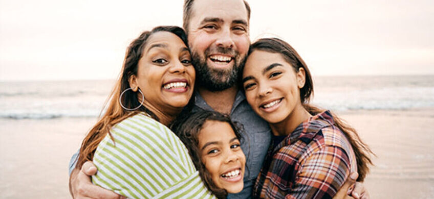 Family hugging and smiling