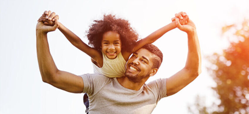father and daughter playing outside